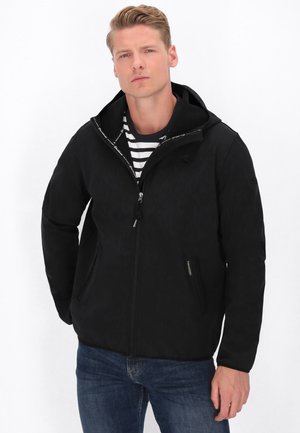 Sort zip-up jakke med hætte, tekstureret stof, to forlommer og indvendig mønstret foret. Bæres over en stribet skjorte.