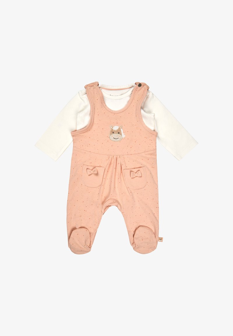 Pink cotton overall with adjustable straps, featuring a horse face design and two front pockets with bow accents. Long-sleeve white top underneath.