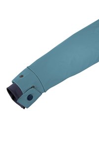 Blue waterproof jacket sleeve with a smooth texture, featuring a contrasting navy cuff and two silver snap buttons.