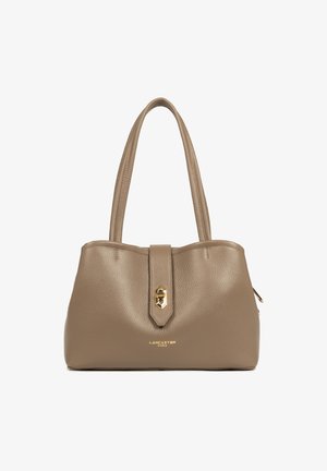 Sac à main en cuir beige avec deux poignées, finition texturée, quincaillerie dorée et fermeture à fermoir central. "Lancaster Paris" embossé en bas.