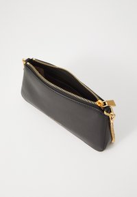 Black leather clutch bag with a zipper closure and gold metal accents. Smooth texture with a minimalist design and interior compartments.