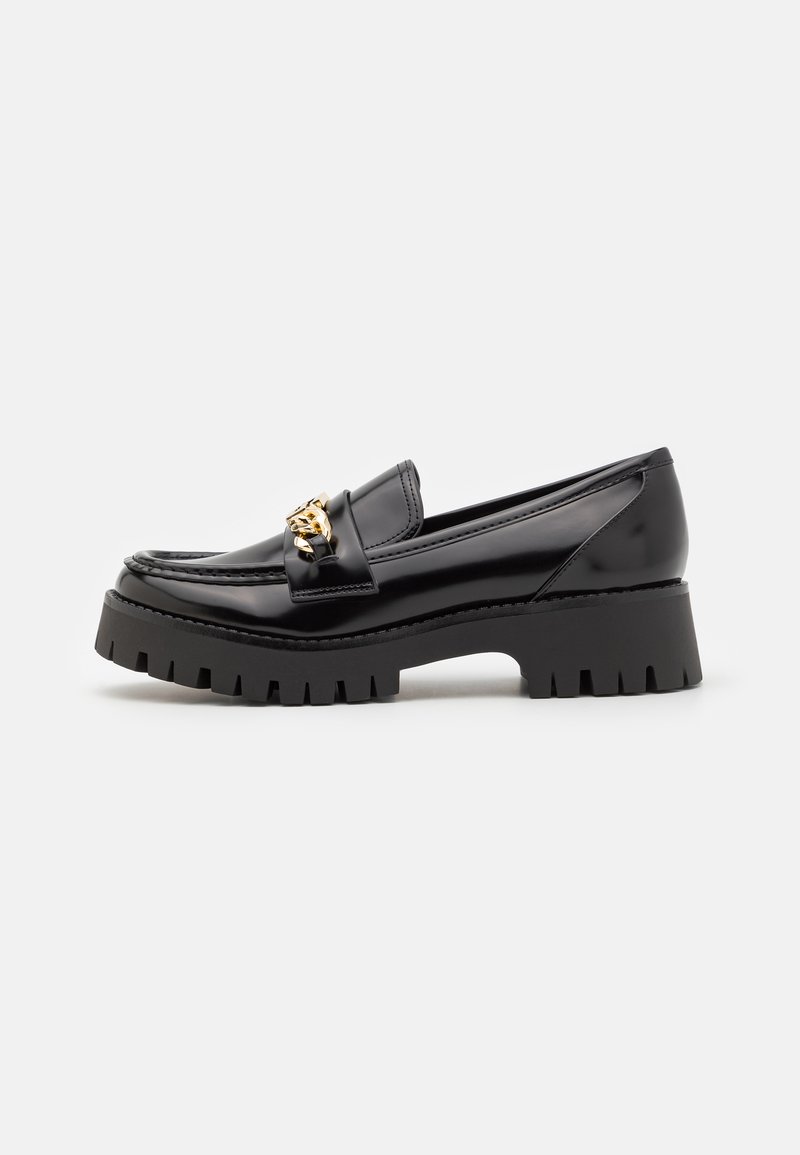 Black patent leather loafers with a thick, serrated black sole and a gold hardware accent on the front. Smooth texture, classic design.