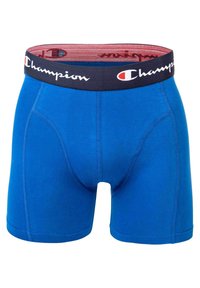 Modre bokserice iz bombažne mešanice, ki imajo mornarsko elastiko s logotipom "Champion" in ravne šive za udobje.