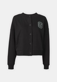 Zwart cropped vest van zachte stof, met een ronde halslijn, knoopsluiting aan de voorkant, twee voorzakken en een groen embleem op de linkerborst.