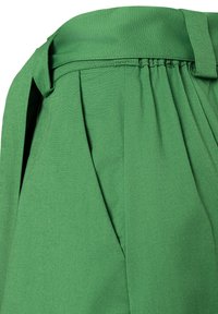 Green high-waist pants with a fabric belt, front pleats, and an elasticized waistband detail on the right side.