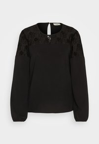 Sort langærmet bluse med tekstureret blonde yoke og nøglehul detalje i ryggen. Tæt siddende bodice med let pufærmer. Blødt stof.