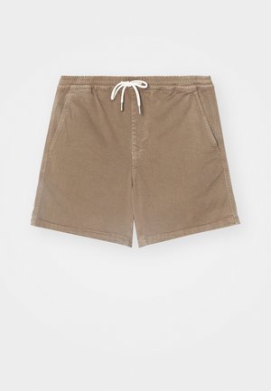 Beige uimapidsaat pehmeast kangast, millel on elastne vöökoht ja stringiga, küljetaskud ja sirge sääre disain.