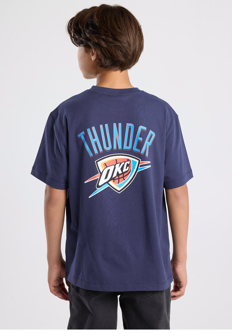 Navy blue cotton t-shirt featuring a large "THUNDER" text and OKC logo in vibrant colors on the back. Short sleeves and relaxed fit.