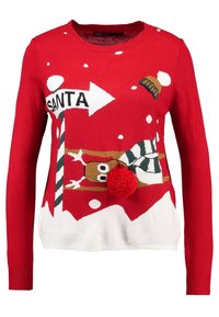 Pull en maille rouge avec un design festif incluant un renne, de la neige et un grand pompon rouge à l'avant. Base blanche en bas.