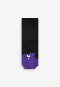Mustat sukat, joissa on violetti sarjakuvamonsterin kuvio, jossa on yksi silmä ja torahampaat. Sukat on valmistettu pehmeästä kankaasta, jossa on ribbitettu pinta.