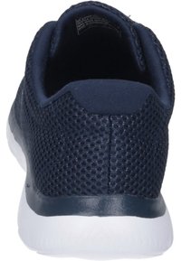 Navy blue athletic shoe with a mesh upper, cushioned sole, and minimalistic design. Features a white rubber outsole and textured back.