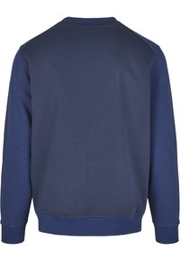 Marineblauwe sweatshirt met een gladde textuur, voorzien van een ronde hals, geribbelde manchetten en een rechte zoom, met contrasterende schouderpanelen.