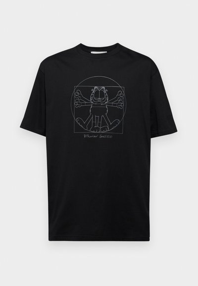 Črna bombažna majica z belim konturo grafiko risanega mačka z razprtimi rokami, postavljenega v središčno krožno zasnovo.