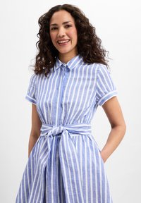 Blue and white striped dress with short sleeves, button closure, collar, and a tied waist detail. Made from a light, textured fabric.