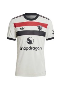 Hvit kortermet fotballdrakt med svarte, røde og marineblå horisontale striper, med et emblem og "Snapdragon"-logoen på fronten.