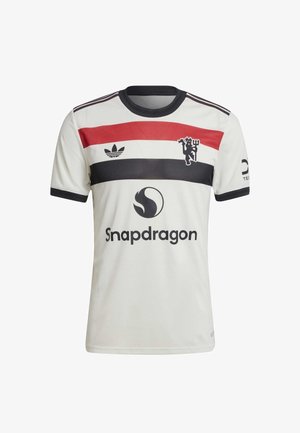 Jersey de fútbol blanca de manga corta con franjas horizontales negras, rojas y azul marino, que presenta un emblema y el logo "Snapdragon" en la parte frontal.