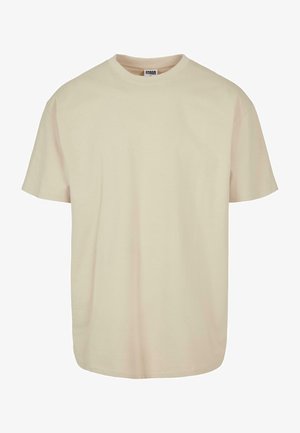 Short sleeve t-shirt in light beige cotton with a crew neckline, featuring a relaxed fit and smooth texture, no visible patterns or accents.