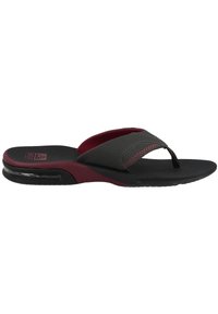 Black and burgundy flip-flop sandal with a textured upper, cushioned footbed, and clear air pocket in the sole for comfort and support.