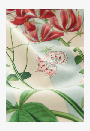 Floral fabric featuring red lilies and delicate pink flowers on a light blue background, with green leaves and intertwining vines.