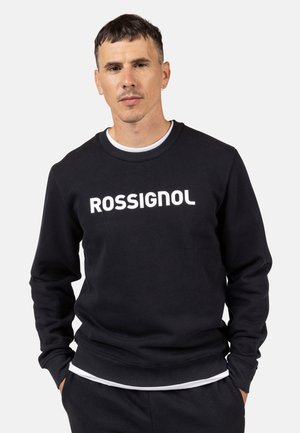 Black sweatshirt made of cotton, featuring a ribbed crew neck, long sleeves, and white "ROSSIGNOL" logo across the front.