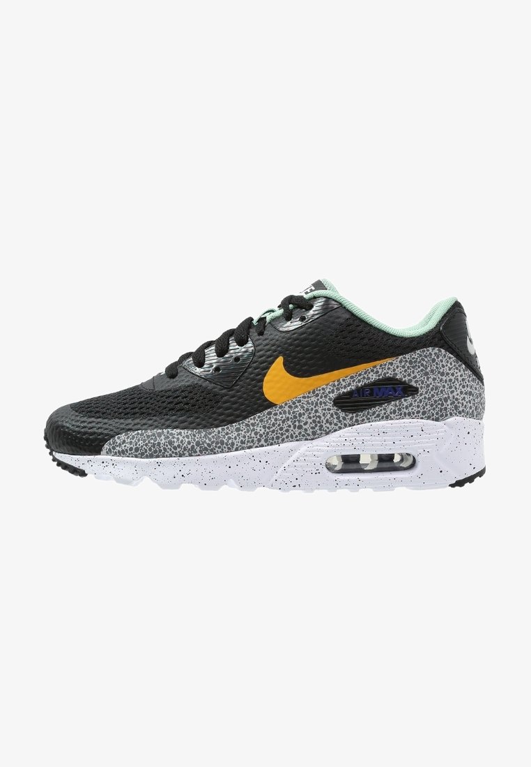 Baskets Nike Air Max noires et grises avec logo jaune, semelle intermédiaire tachetée, lacets noirs et doublure intérieure vert clair.