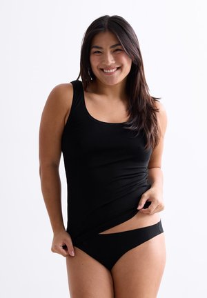Black tank top made of smooth fabric with a rounded neckline, paired with matching bikini bottoms. Model presents a relaxed pose.