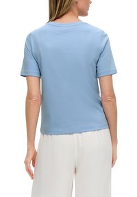 Light blue, short-sleeve cotton t-shirt with a round neckline and a straight hem, featuring a smooth texture and minimal stitching details.