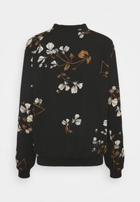 Czarna bluza z kwiatowym wzorem w kolorach kremowym i brązowym. Posiada dopasowany pas i mankiety, długie rękawy oraz okrągły dekolt.
