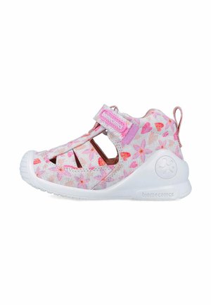 Sandalias ligeras para niños en blanco y rosa, con un patrón floral, correa ajustable y aberturas de ventilación en los laterales.