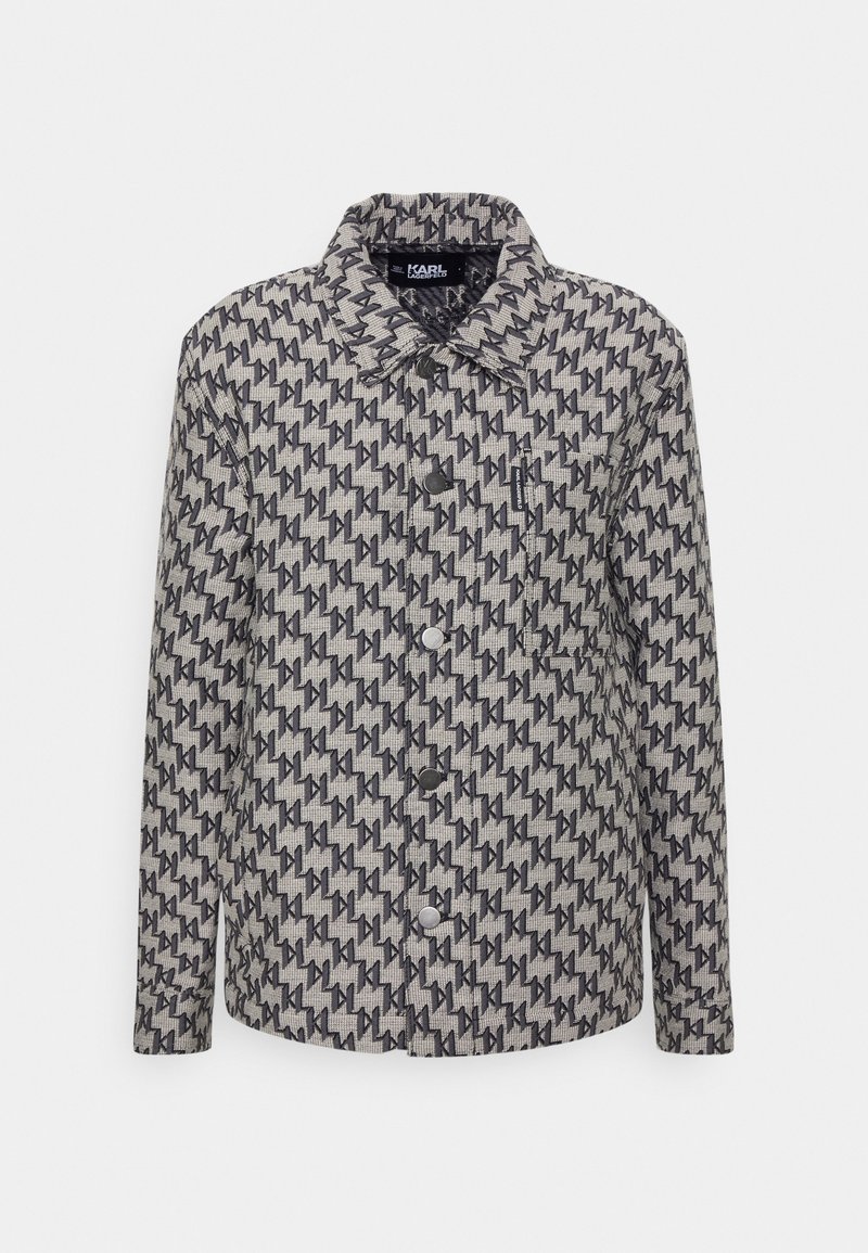 Stylish jacket with a light gray fabric, featuring a repetitive dark pattern, a collar, button closure, and long sleeves.