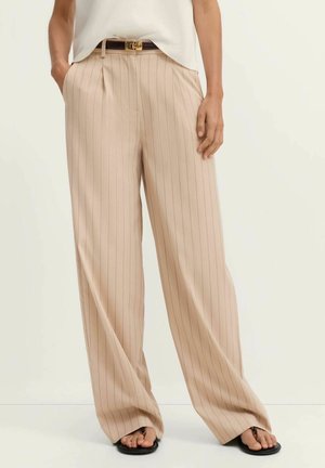 Beige wide-leg striped trousers with front pleats, featuring a brown belt with a gold buckle. Smooth fabric with vertical light and dark stripes.