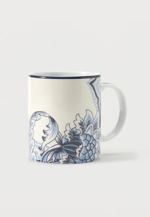 White ceramic mug with blue floral and paisley patterns and a navy rim, shown against a plain light background.