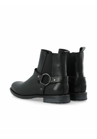 Svarta läderankelboots med rund tå, med elastiska paneler och ett dekorativt rem med en metallring, gummisula och lågt klack.