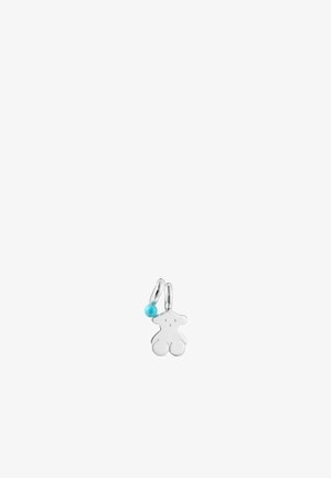 Ciondolo a forma di orso in argento con superficie liscia, appeso a un anello. Presenta un piccolo accento in bead di turchese.