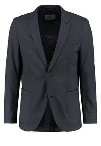 Dunkelgraue Sportjacke aus strukturiertem Material. Verfügt über zwei Knöpfe, zwei Vorderleisten und eine Brusttasche. Das Innenfutter ist gemustert.