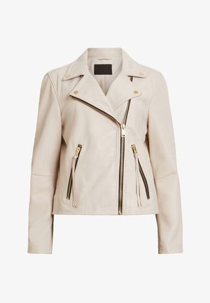 Beige leather motorcycle jacket featuring asymmetrical zippers, gold hardware, and zippered pockets. Smooth texture with a fitted design.