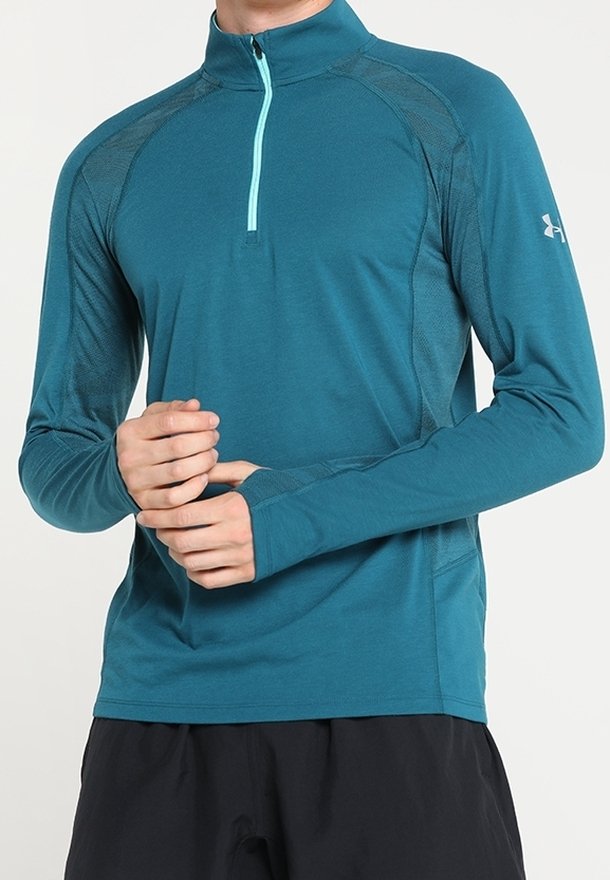 Teal langmouwige sporttop met een half-rits kraag en een contrasterende lichtblauwe rits. Heeft een gestructureerde stof en een aansluitend ontwerp.