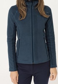 Fleece jacket in dark blue with a full zip, raglan sleeves, side pockets, and contrasting stitching. Soft texture and tailored fit.