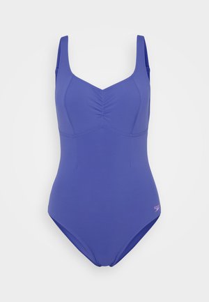 Maillot de bain une pièce violet uni avec de larges bretelles et un détail froncé au niveau de la poitrine, présenté sur un fond blanc uni.