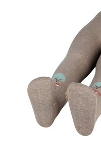 Braune Baumwollleggings mit einem Baumdesign und bunten Akzenten. Die Textur ist glatt und schmiegt sich eng an Füße und Beine.