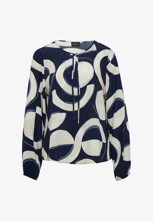 Blouse marine avec de grands motifs circulaires crème et bleu. Présente un col rond, un lien à tirage et de longues manches avec des poignets élastiques.