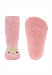 Rosa Socken mit einer weichen Textur, die ein Hasengesicht-Design in Gelb und Schwarz aufweisen. Die Sohle verfügt über strukturierte Griffdetails.