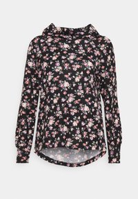 Haut noir à manches longues à motifs floraux, présentant un col bénitier, un tissu doux et un ourlet arrondi. Le design affiche de petites fleurs roses et blanches.