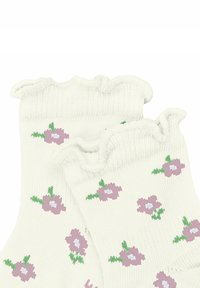 Białe skarpetki kostkowe z falbaniastymi krawędziami, ozdobione wzorem małych fioletowych kwiatków z zielonymi liśćmi. Miękka, dziana tekstura.