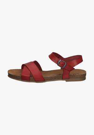 Red leather sandals with crossed straps and a buckle on the ankle. Cushioned cork footbed and flat rubber sole.
