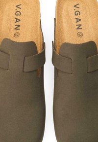 Olive green slip-on clogs with a smooth texture, featuring a single strap and natural cork insoles with brand name and size printed inside.