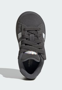 Black athletic shoe with a textured upper, round laces, and white stripe accents; features a cushioned insole and rubber outsole.