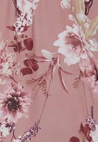 Tessuto a fantasia floreale con sfondo rosa, grandi fiori bianchi e borgogna, e fogliame verde con dettagli intricati e diverse trame.