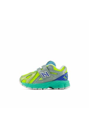 Children’s athletic sneaker with neon yellow mesh, grey and blue overlays, teal sole, and Velcro strap with "N" logo.