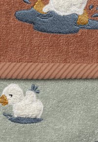 Two towel sections: top in soft terracotta with embroidered duck, bottom in light green featuring white duck with blue accents, textured fabric.